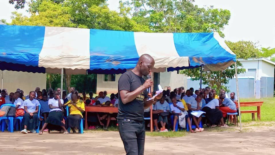 Holistic school support session outdoors under a tent